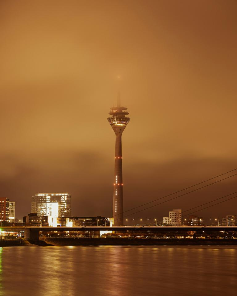 Escort Dusseldorf - The Rhine Tower at night with an orange sky Escort Dusseldorf - The Rhine Tower at night with an orange sky
